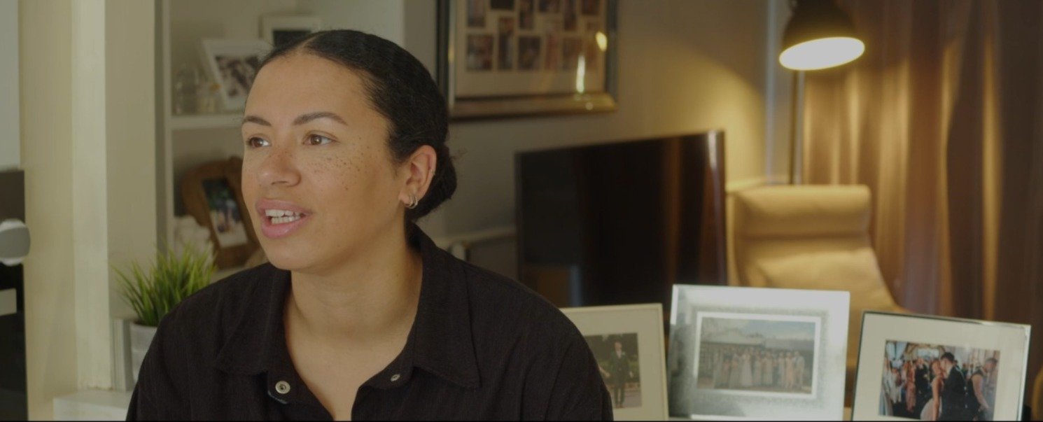 A woman being interviewed on location for a testimonial piece